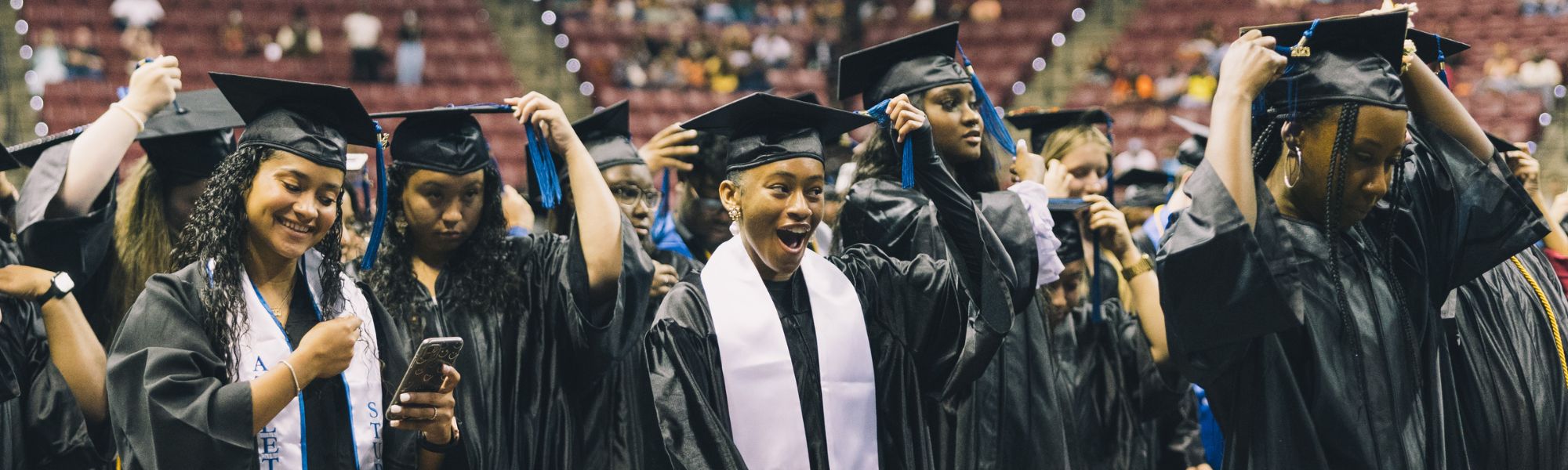 group of female students moving their tassels over during commencement