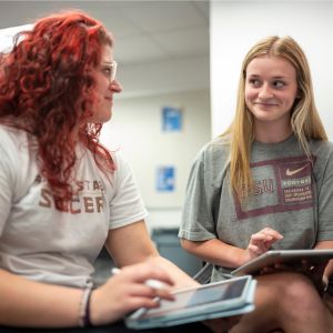 Student sitting at desk focusing on the professor