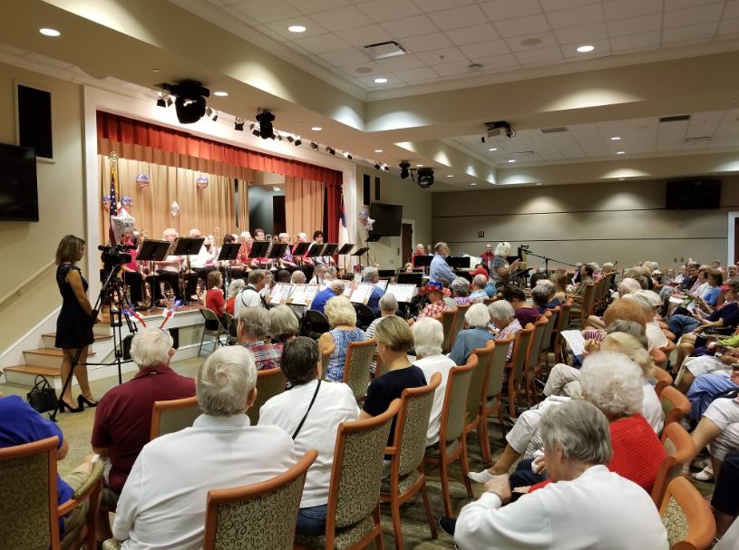 Band performing on stage to crowd of retirees.