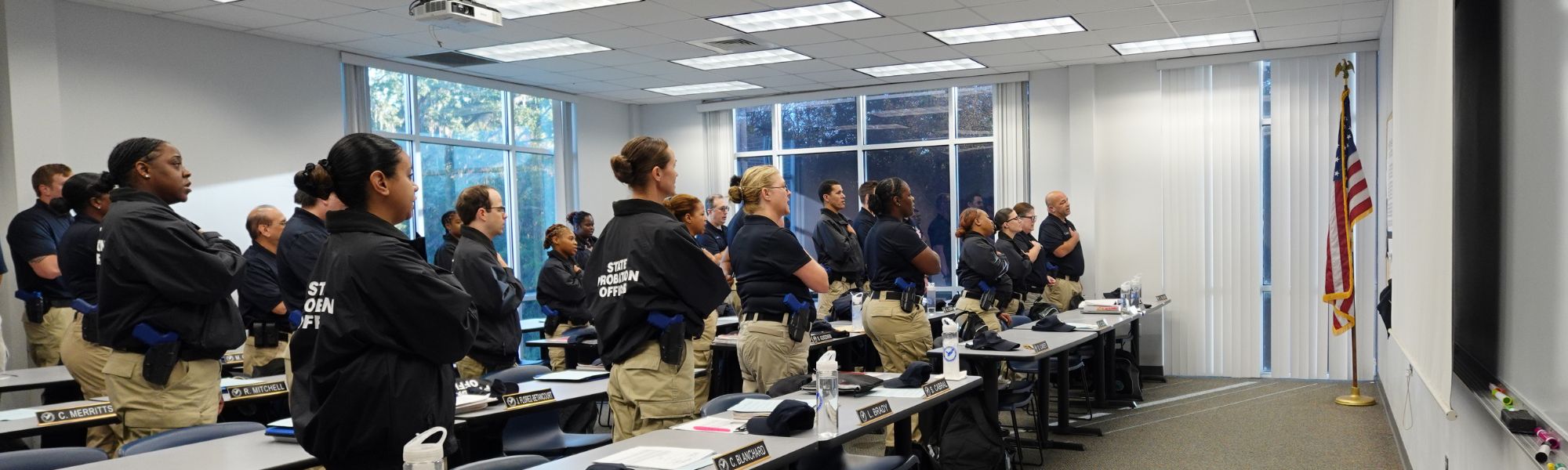 Correctional students saying the pledge of allegiance in a classroom.