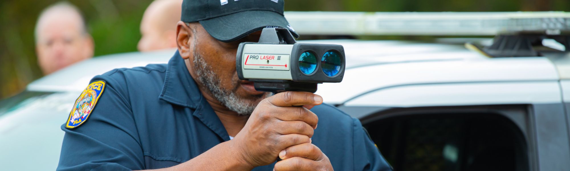 Officer practicing with radar speed detector.