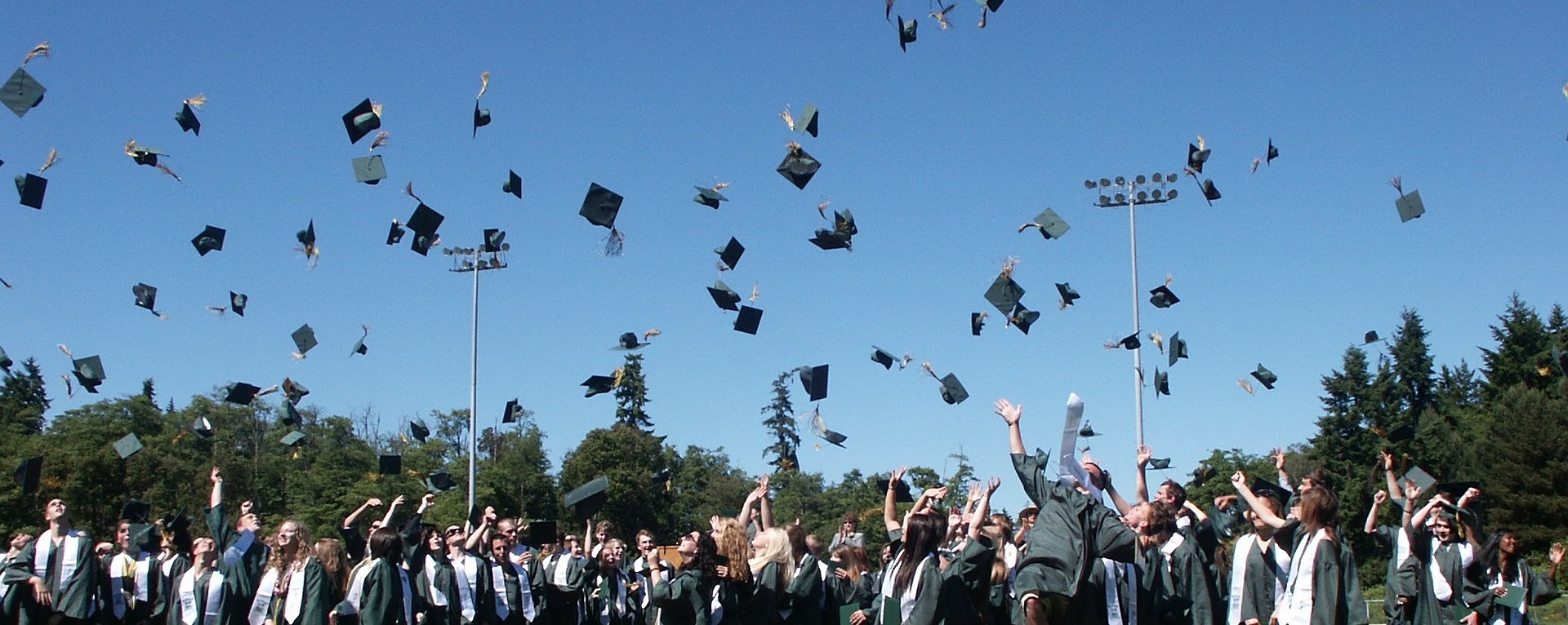 Graduates throw their caps in the air