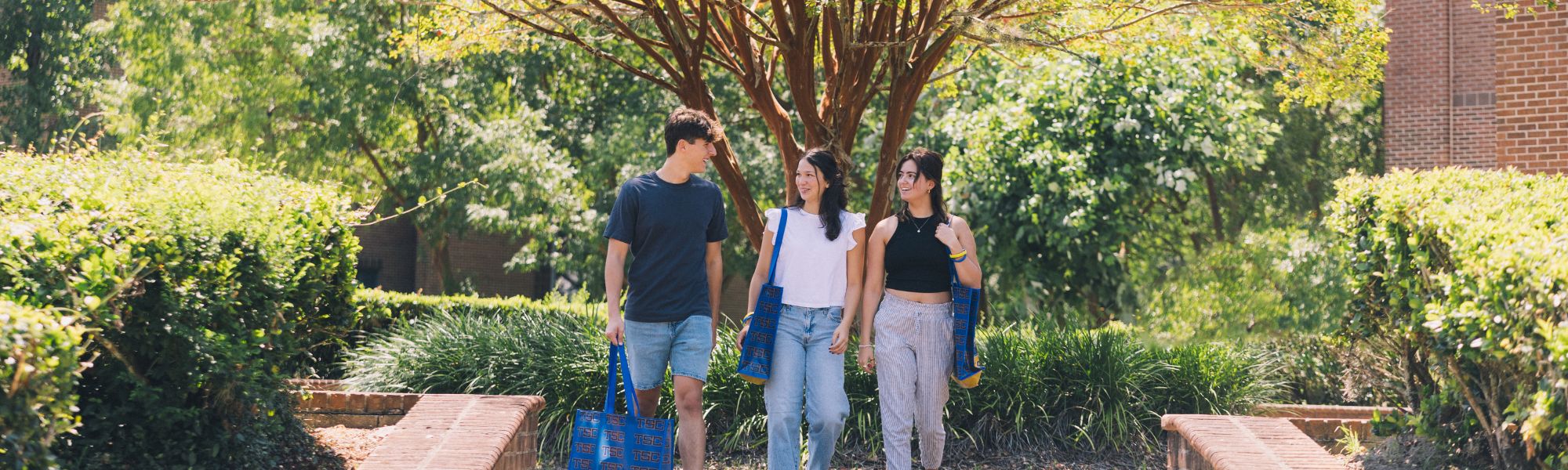 Smiling students walking together on campus.